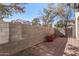 Small backyard with block wall and flowering bush at 106 N 66Th Ave, Phoenix, AZ 85043