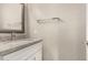 Small bathroom with granite countertop, white sink, and a mirror at 106 N 66Th Ave, Phoenix, AZ 85043