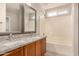 Updated bathroom with double vanity, granite countertop, and a bathtub at 106 N 66Th Ave, Phoenix, AZ 85043