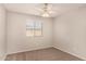 Well-lit bedroom featuring a ceiling fan and window coverings at 106 N 66Th Ave, Phoenix, AZ 85043