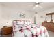 Bright bedroom with ceiling fan and wood furniture at 10906 W Tropicana Cir, Sun City, AZ 85351