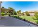 Large backyard with covered patio, grassy lawn, and desert landscaping at 1116 W Courtney Ln, Tempe, AZ 85284