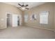 Bright bedroom featuring a ceiling fan and ample closet space at 1116 W Courtney Ln, Tempe, AZ 85284