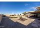 Backyard with gravel, artificial turf, and a covered patio at 11185 W Palmeras Dr, Sun City, AZ 85373