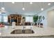 Kitchen island with granite countertops and stainless sink overlooking dining and living areas at 11990 E Pivot Peak --, Gold Canyon, AZ 85118