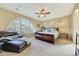 Main bedroom with carpeted floors, a large bed, and a comfy armchair at 12692 N 152Nd Ave, Surprise, AZ 85379