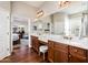 Spa-like bathroom with double vanity and access to bedroom at 13286 W Micheltorena Ct, Sun City West, AZ 85375