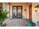 Inviting front entry with double doors and a brick walkway at 13286 W Micheltorena Ct, Sun City West, AZ 85375