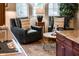 Cozy sitting area with leather armchairs, a coffee table, and decorative pillows at 13286 W Micheltorena Ct, Sun City West, AZ 85375