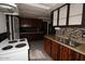 White stove and wood cabinets in a galley style kitchen at 1331 E Mckinley St, Phoenix, AZ 85006