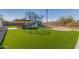 Backyard with artificial turf, gazebo, a playground, and perimeter fence at 134 N 87Th St, Mesa, AZ 85207