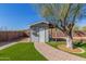 Charming backyard shed with a covered area and a brick pathway, perfect for outdoor projects or storage at 134 N 87Th St, Mesa, AZ 85207
