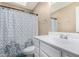 Clean bathroom with modern fixtures, a vanity with storage, and a patterned shower curtain at 134 N 87Th St, Mesa, AZ 85207