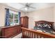 Charming bedroom with a large window, dresser, and wood bed frame at 134 N 87Th St, Mesa, AZ 85207