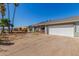 Wide driveway leading to a well-kept single-story home with a porch, offering ample parking at 134 N 87Th St, Mesa, AZ 85207