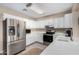 Well-lit kitchen with stainless steel appliances, white cabinetry, and ample counter space at 134 N 87Th St, Mesa, AZ 85207