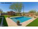 Backyard pool featuring a gazebo, a beautiful tree, and manicured landscaping at 134 N 87Th St, Mesa, AZ 85207