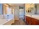 Bathroom boasts double sinks, soaking tub, and shower at 15058 W Fillmore St, Goodyear, AZ 85338