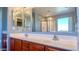 Double vanity with large mirror and bright lighting at 15058 W Fillmore St, Goodyear, AZ 85338