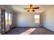 Well-lit bedroom with large windows and carpet flooring at 15058 W Fillmore St, Goodyear, AZ 85338