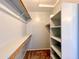 Walk-in closet with shelves and hanging rods at 15058 W Fillmore St, Goodyear, AZ 85338