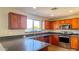 Kitchen with wood cabinets, stainless steel appliances, and a large island at 15058 W Fillmore St, Goodyear, AZ 85338