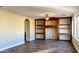 Living room with built-in shelving and hardwood floors at 15058 W Fillmore St, Goodyear, AZ 85338