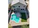 Aerial view of a kidney shaped pool with artificial turf at 15058 W Fillmore St, Goodyear, AZ 85338
