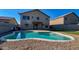 Inviting kidney-shaped pool with pebble tec finish in a spacious backyard at 15058 W Fillmore St, Goodyear, AZ 85338