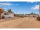 Large backyard with gravel, some landscaping, and storage at 1561 W 5Th St, Mesa, AZ 85201
