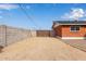 Backyard with gravel, gate, and partial view of the house at 1561 W 5Th St, Mesa, AZ 85201
