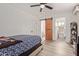 Cozy bedroom with barn door to bathroom and ceiling fan at 1561 W 5Th St, Mesa, AZ 85201