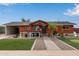 Brick ranch home with landscaped yard, putting green, and walkway at 1561 W 5Th St, Mesa, AZ 85201