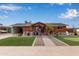 Charming brick home with a landscaped front yard and putting green at 1561 W 5Th St, Mesa, AZ 85201