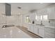Bright kitchen with white cabinets, stainless steel appliances, and quartz countertops at 1561 W 5Th St, Mesa, AZ 85201
