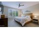 Spacious bedroom with ceiling fan and en-suite bathroom at 16918 W Palm Ln, Goodyear, AZ 85395