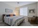 Comfortable bedroom with a king-size bed and sitting area at 16918 W Palm Ln, Goodyear, AZ 85395