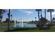 Serene community lake with fountains and palm trees at 16918 W Palm Ln, Goodyear, AZ 85395