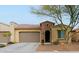 Single-story home with a two-car garage and desert landscaping at 16918 W Palm Ln, Goodyear, AZ 85395