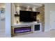 Modern electric fireplace with stone surround and built-in shelving at 16918 W Palm Ln, Goodyear, AZ 85395