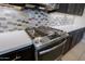Gas cooktop with stylish backsplash in kitchen at 16918 W Palm Ln, Goodyear, AZ 85395