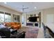 Living room features a fireplace, large TV, and comfortable seating at 16918 W Palm Ln, Goodyear, AZ 85395