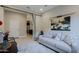 Small office with a couch, desk, and view into the kitchen at 16918 W Palm Ln, Goodyear, AZ 85395