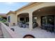 Covered patio with seating area, fire pit, and outdoor TV at 16918 W Palm Ln, Goodyear, AZ 85395