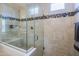 Spacious shower with glass enclosure and built-in seat at 16918 W Palm Ln, Goodyear, AZ 85395