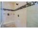 Large walk-in shower with tiled walls and built-in seat at 16918 W Palm Ln, Goodyear, AZ 85395