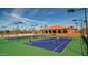 Well-lit tennis courts with players enjoying a game at 16918 W Palm Ln, Goodyear, AZ 85395