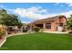 This backyard features a well manicured lawn and leads to a refreshing pool area at 18001 N 53Rd St, Scottsdale, AZ 85254