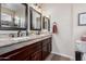 Stylish bathroom with double sinks, granite countertop, and dark wood cabinetry at 18001 N 53Rd St, Scottsdale, AZ 85254