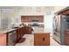 Well-lit kitchen featuring stainless steel appliances, ample counter space, and a functional center island at 18001 N 53Rd St, Scottsdale, AZ 85254